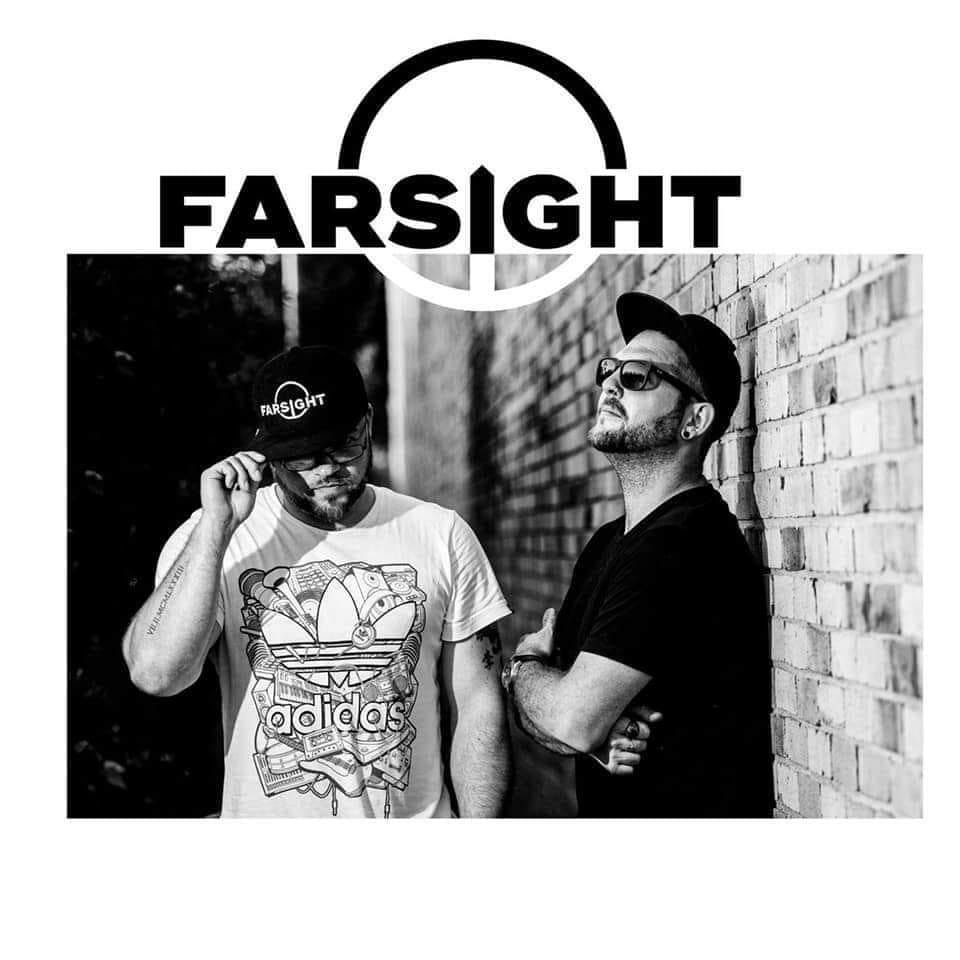 DnB Duo Farsight on Codesouth radio, both standing against a brick wall 